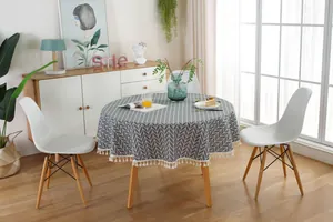 Detailed view of grey arrow pattern round tablecloth with white fringe tassels