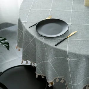 Modern embroidered plaid round tablecloth with tassels in light sage green and linen texture