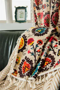 Macro detail of bohemian floral linen curtain with vibrant patterns and elegant fringe trim