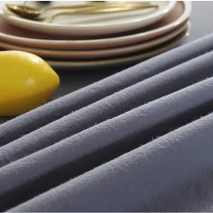 Close-up of vintage ruffled tablecloth in dark grey blue with soft textured fabric