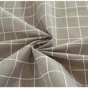 Close-up of sage green plaid tablecloth fabric showing soft cotton linen texture