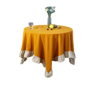 Retro mustard yellow round tablecloth with elegant ruffled edge and linen texture