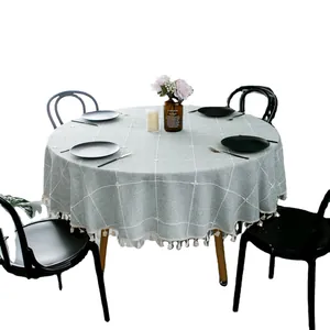 Gray round tablecloth with white grid pattern and tassel trim for dining tables