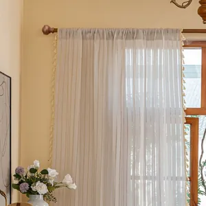 Detail of Nordic linen curtain featuring vertical stripes and elegant side tassels