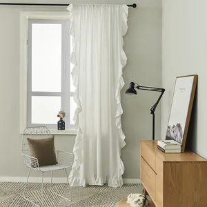 Detail of white ruffle curtains with elegant pleated edges in a minimalist Nordic style