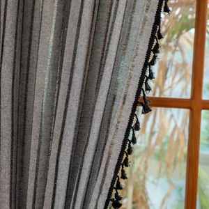 Detailed texture of cotton linen striped curtain with black tassel fringe trim