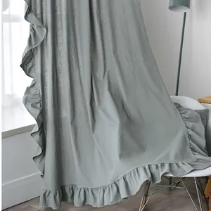 Detail of sage green ruffled curtains with natural fabric texture in a cozy living room
