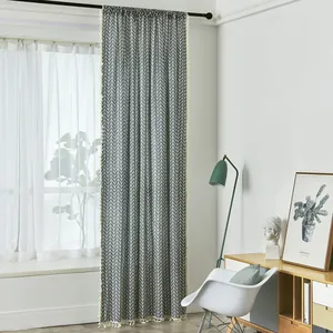 Detailed view of geometric herringbone linen curtain featuring decorative cream tassels