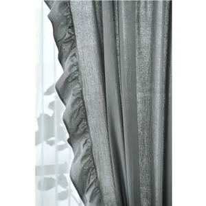 Close-up of neutral grey linen curtain featuring elegant wide ruffle edges and texture