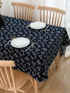 Close-up of ethnic navy blue tablecloth with white floral pattern on a wood table