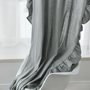 Close-up of grey-green curtain fabric showing natural bamboo texture and ruffled edges