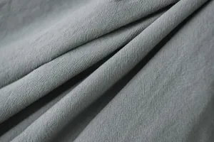 Macro texture detail of gray double-layer ruffled curtains with breathable weave