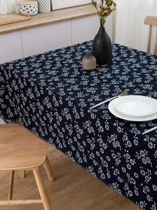 Detailed texture of navy blue batik tablecloth with white floral pattern and table setting