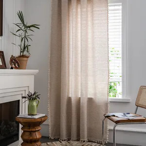 Detailed view of Nordic linen curtains with vertical stripes and tassel trim accents