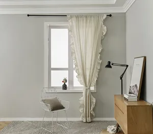 Detail of cream French ruffle curtains with natural linen texture and woven tiebacks