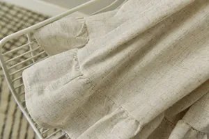 Macro shot of natural cotton linen fabric texture with layered ruffle sewing details