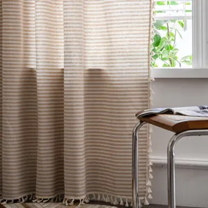Detailed view of linen blend striped curtain with delicate beige tassel fringe edges