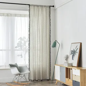 Detail of Nordic grey and white geometric cotton linen curtain with black tassel trim