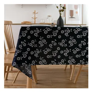 Rectangular navy blue linen tablecloth with white daisy floral pattern on wood table