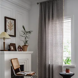 Nordic cotton linen curtain with black white stripes and pompom fringe in cozy living room