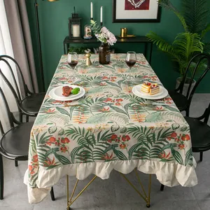 Nordic tropical leaf print tablecloth with ruffled edges in a cozy home setting
