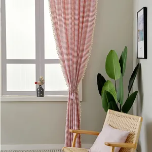 Japanese style red striped linen curtain with tassels in a bright minimalist interior