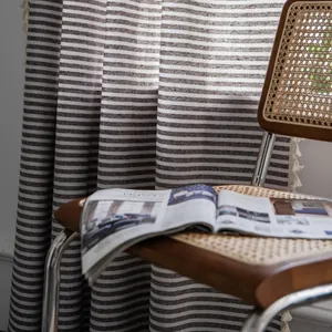 Detail of Nordic striped cotton linen curtain with decorative fringe edge and tassels
