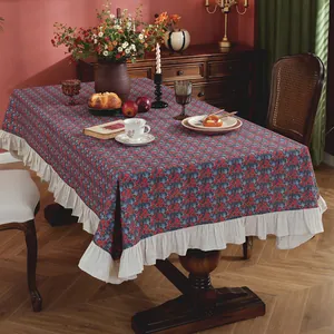 Vintage rectangular tablecloth with red floral prints and ruffled cream borders