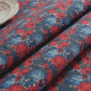 Close-up of vintage cotton linen fabric with blue scrolls and red floral patterns
