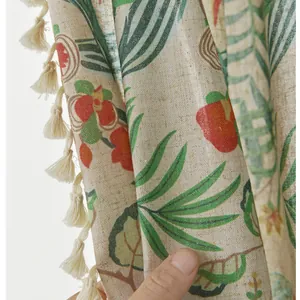 Detail of linen stripe curtain with tropical leaf print and cream tassel fringe trim
