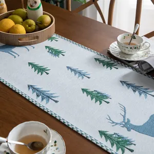 Christmas table runner with embroidered trees and reindeer on grey linen fabric