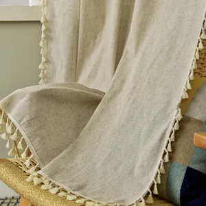 Close-up of Nordic cotton linen curtain fabric featuring detailed tassel fringe edges