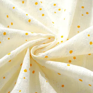Detailed macro view of cream linen fabric with delicate 3D daisy floral embroidery