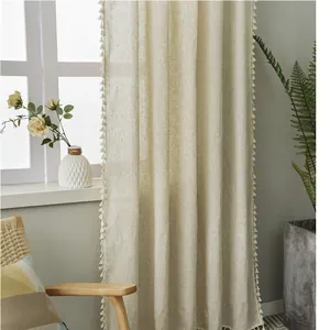 Close-up of linen stripe curtain fabric with delicate tassel edges in a cozy interior