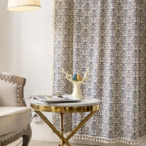Vintage blue damask cotton linen curtain with elegant tassel trim in a cozy living room