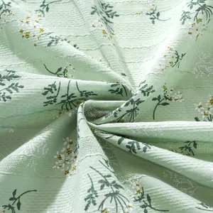 Detailed macro view of soft seersucker fabric with elegant floral embroidery and texture