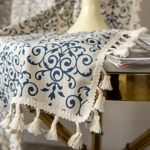 Detail of blue floral cotton linen fabric with tassel edges for home decor