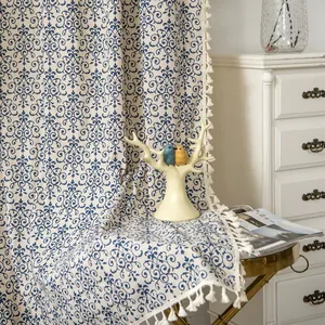 Detail of blue damask pattern on thick cotton linen fabric with white tassel fringe