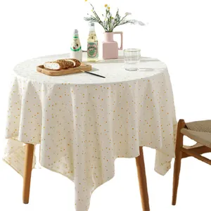 Floral embroidered round tablecloth in cream with yellow polka dots and linen texture