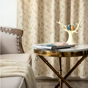 Detail of floral curtains with vintage leaf patterns and delicate white lace trim edges
