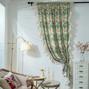 Detail of tropical palm leaf print curtain with elegant ruffle edge and drapery