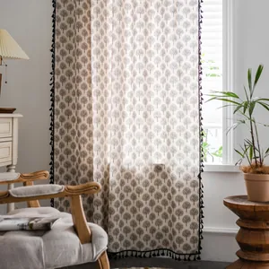 Detailed close-up of tree patterns and black pompom fringe on Nordic window curtains