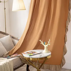 Detail von ingwergelben Vorhängen aus Baumwollleinen mit eleganten beigen Rüschenkanten