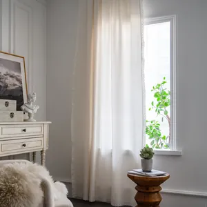 Cortina blanca minimalista de algodón y lino con bordes de encaje en un ambiente cálido