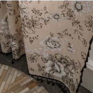 Detail of vintage floral cotton linen curtain with black tassel fringe and peony print