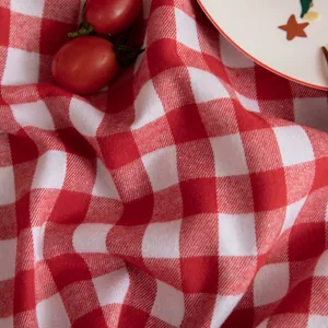 Detail of red and white gingham tablecloth fabric texture with rustic table setting