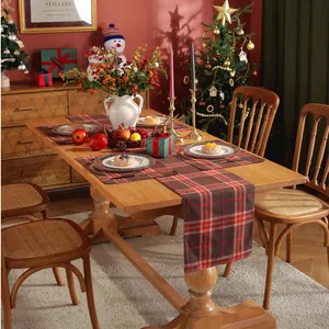Classic red plaid table runner and mat set on a wooden table with Christmas decor