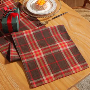 Close-up of a festive red and brown checkered cotton linen table runner on wood