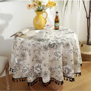 European vintage round tablecloth with floral pattern and black tassels on cotton linen