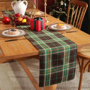 Macro detail of Christmas plaid table runner in green and beige rustic cotton linen